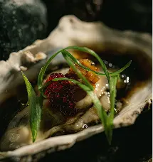 Scallops with XO sauce and tare, part of the exclusive Nikkei menu at a gourmet restaurant in Escazú, Costa Rica.