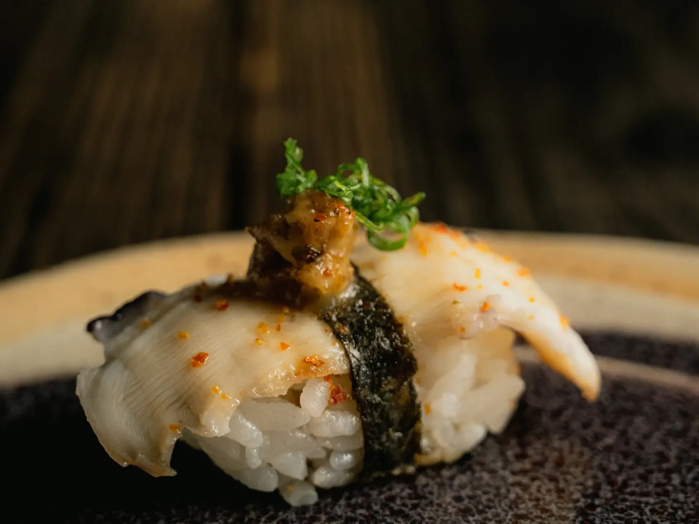 Batayaki octopus with eel sauce and togarashi, a unique fusion dish at a luxury restaurant in Costa Rica's GAM.